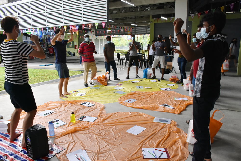 Migrant workers singing a birthday song for Singapore as part of the mindfulness activity. (Photo by Li Fumin)